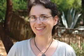 A picture of a woman, Laura Markowitz, with glasses smiling. 